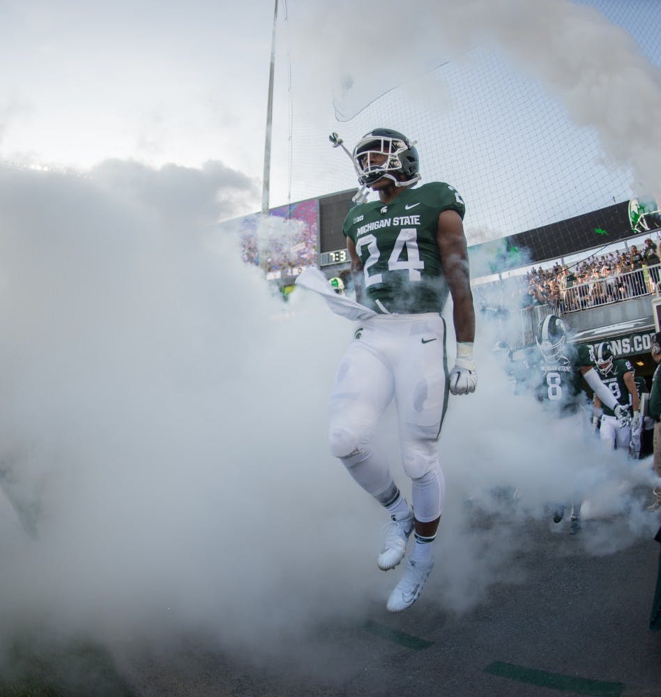 <p>Freshman running back Elijah Collins (24) runs out of the tunnel prior to the game against Utah State on Aug. 31, 2018 at Spartan Stadium. </p>