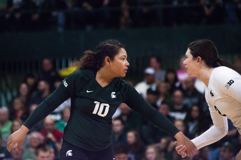 Junior defensive specialist Abby Monson (10) talks with junior outside hitter Autumn Bailey (2) before a play during the game against Michigan on Nov. 12, 2016 at Jenison Fieldhouse. The Spartans defeated the Wolverines, 3-1. 