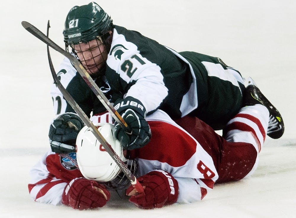	<p>Senior forward Anthony Hayes falls on top of Miami (Ohio) defenseman Matthew Caito during the game on Saturday, March 16, 2013, at Cady Arena of the Goggin Ice Center in Oxford, Ohio. <span class="caps">MSU</span> lost to Miami (Ohio) 4-1 in the second game of the second round of the <span class="caps">CCHA</span> playoffs. Danyelle Morrow/The State News</p>