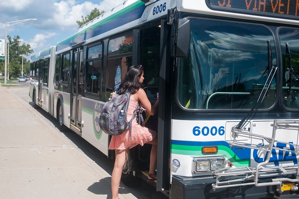 <p>Then-finance and human biology junior Sona Kaur gets on the bus to go to class on Sept. 3, 2014 at the bus stop in front of Brody neighborhood. Many students choose to use the bus to get to different places on campus. Jessalyn Tamez/The State News</p>