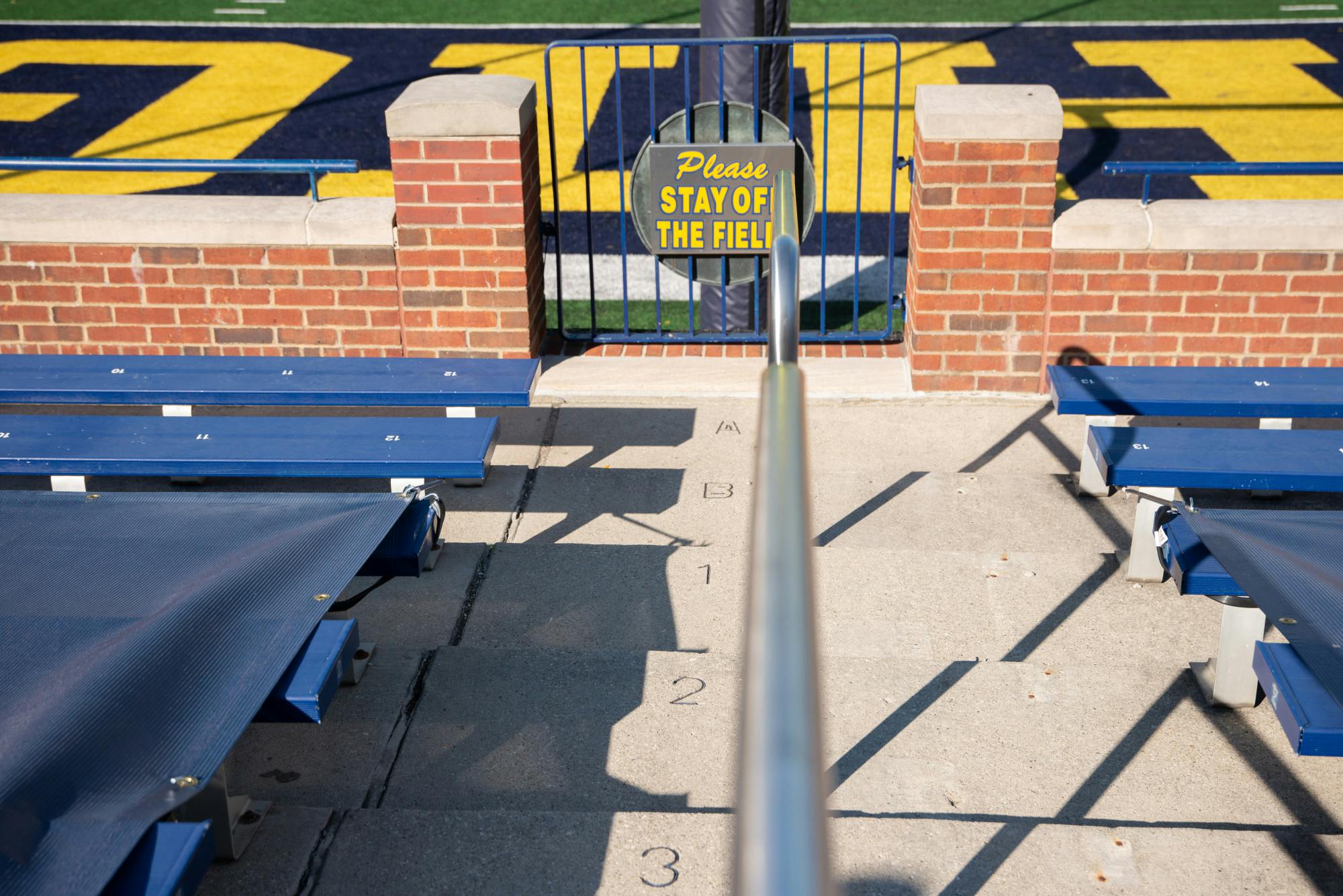 <p>A sign reads &quot;Please Stay Off The Field&quot; in a nearly empty big house on Oct. 31, 2020.</p>