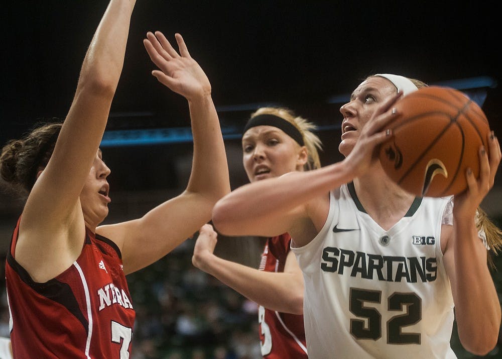 	<p>Junior forward Becca Mills fights through Nebraska forward Jordan Hooper to attempt a shot Jan. 9, 2014, at Breslin Center. The Spartans defeated the Cornhuskers, 70-57. Erin Hampton/ The State News</p>