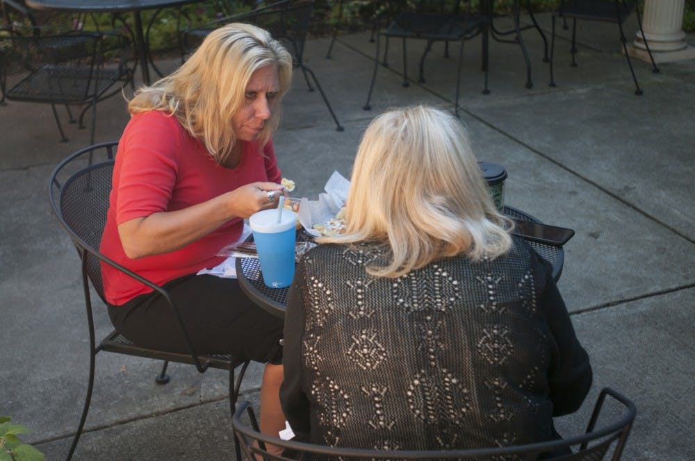 From left, Dewitt resident Shelly Beyer and East Lansing resident Cindy Hughes talk over lunch on Sept. 14, 2016 at Lester and Jewell Morris Hillel Jewish Student Center. Beyer and Hughes are the finance and executive directors of the Lester and Jewell Morris Hillel Jewish Student Center respectively. 