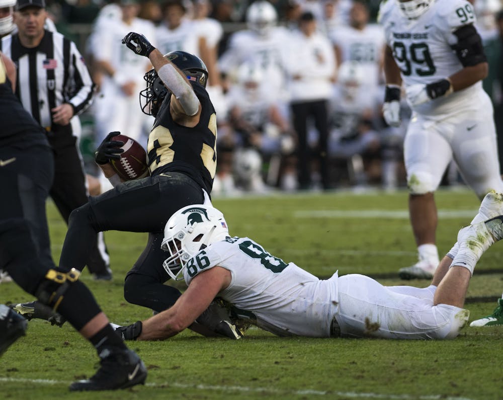 <p>Spartan senior defensive end Drew Beesley (86) tackles Purdue&#x27;s Jackson Anthrop (33) in the MSU&#x27;s match against the Boilermakers at Ross-Ade Stadium in West Lafayette on Saturday, Nov. 6, 2021.</p>