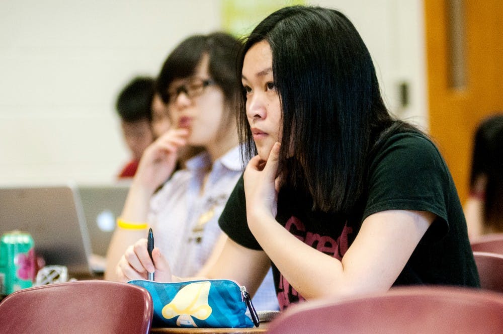 Sophomore business management major Dongfang Wei takes notes during a Wednesday, June 20, 2012 EC 201 class taught by instructor, Yu-Wei Chu at Bessey Hall.  A large number of international students have chose to stay on campus during the summer months. Adam Toolin/The State News