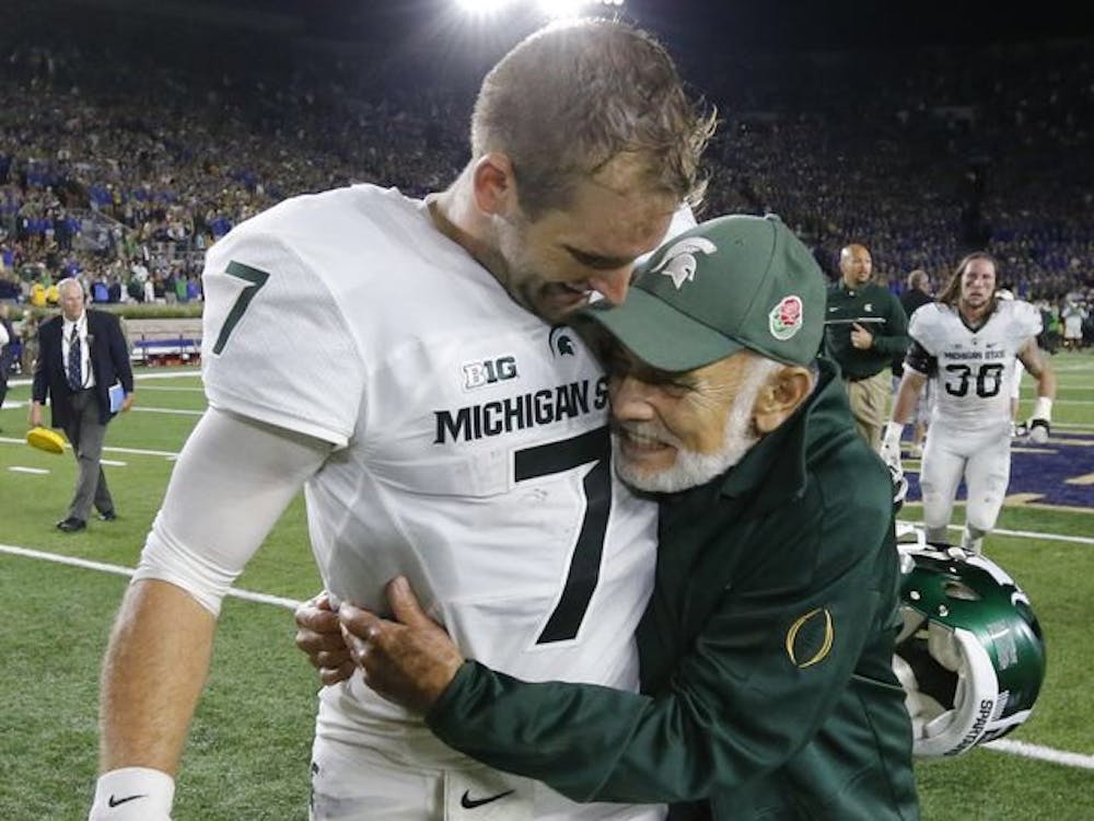 <p>MSU quarterback Tyler O&#x27;Connor and Father Jake Foglio embrace following the Spartans 36-28 win over Notre Dame in 2016. The Spartans were ranked No. 12 in the country at the time but finished the season 3-9, O&#x27;Connor said that the photo of him and Foglio is his favorite from his time at MSU. Photo Courtesy of Tyler O&#x27;Connor. </p>