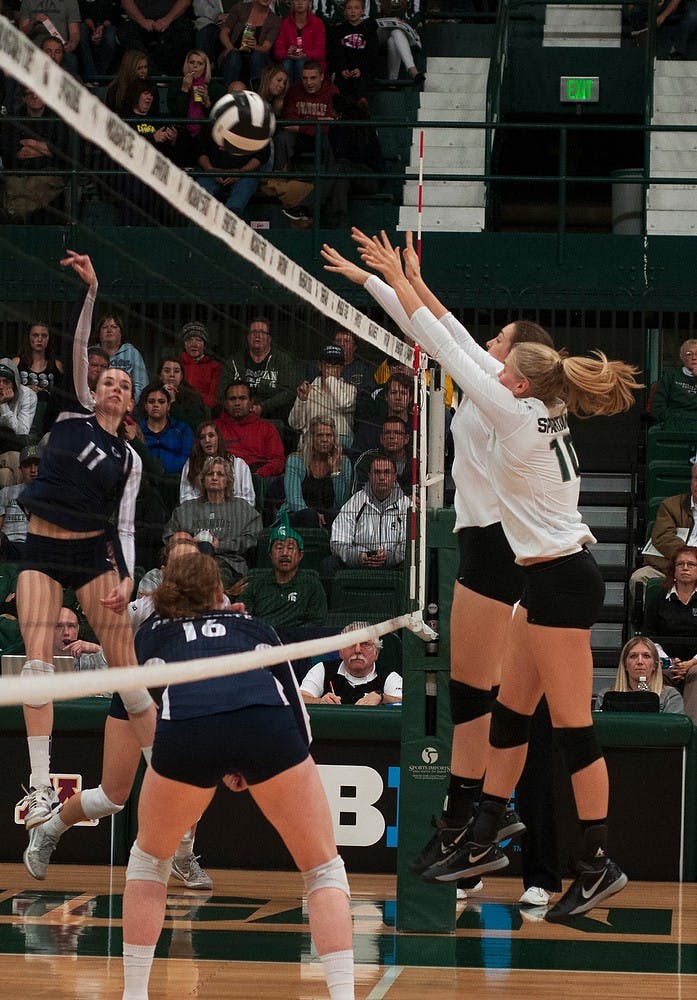 	<p>Senior middle blocker Kelsey Kuipers, left, and freshman middle blocker Allyssah Fitterer, right, block the ball Nov. 2, 2013, at Jenison Field House. <span class="caps">MSU</span> lost to Penn State, 3-0. Margaux Forster/The State News</p>