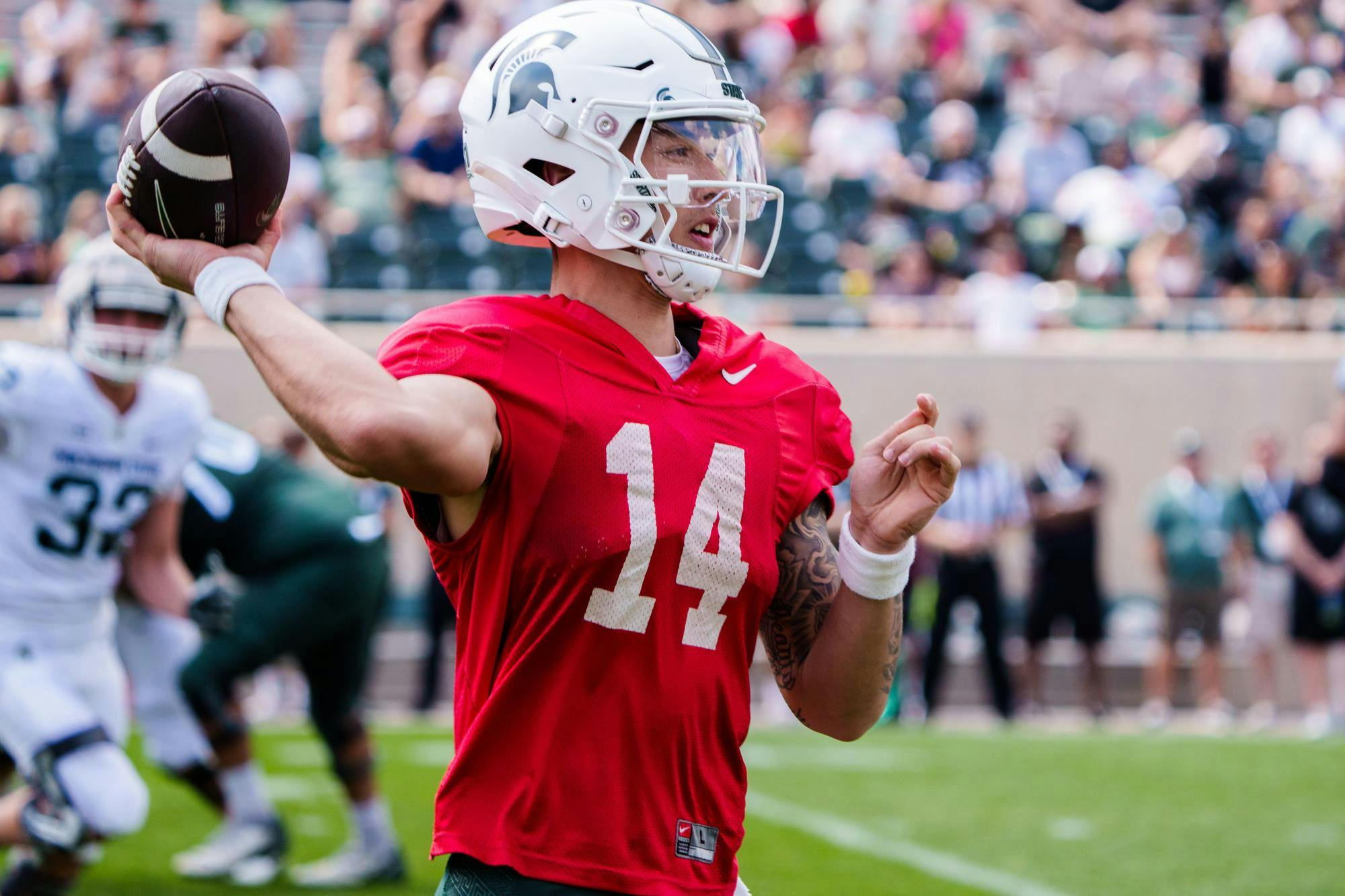 Redshirt junior quarterback Noah Kim (14) throws the ball during the MSU football spring open practice, held at Spartan Stadium on April 15, 2023.