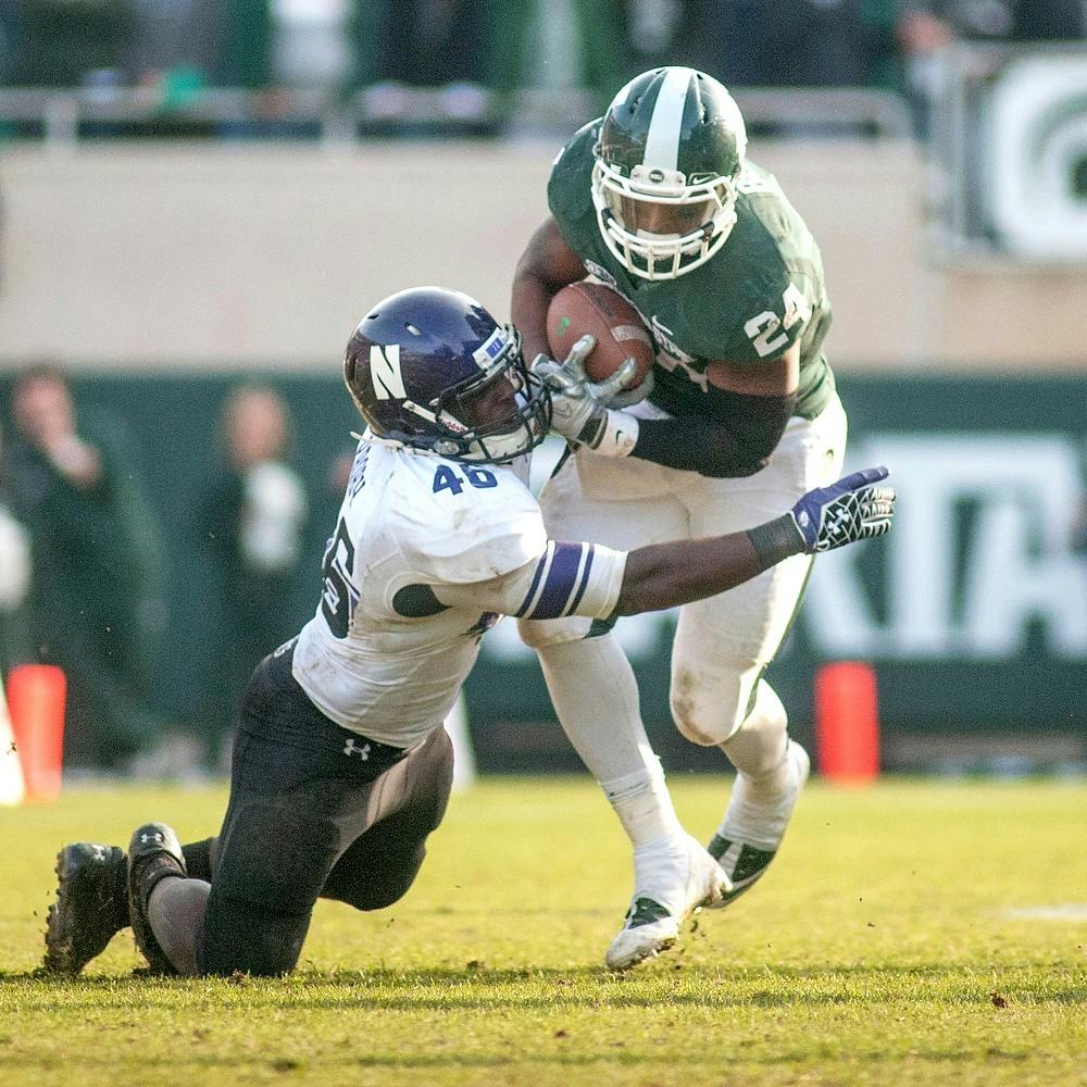 	<p>Junior running back Le&#8217;Veon Bell confronts linebacker Damien Proby on Saturday, Nov. 17, 2012, at Spartan Stadium. Northwestern defeated <span class="caps">MSU</span> 23-20. James Ristau/The State News</p>