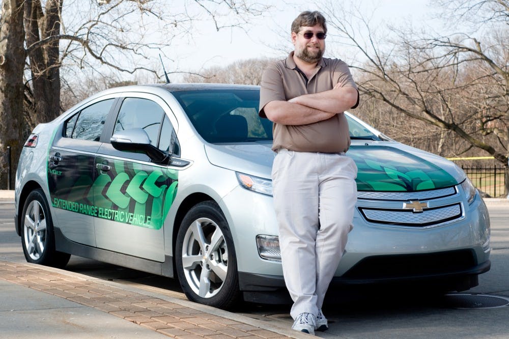 Matt Stehouwer, Technology Manager for the College of Natural Science, owns one of ten Chevy Volt extended range electric vehicles in the state of Michigan, and is one of three in the Lansing area. He has had the car since Feb. 11 where he picked it up in New York City and drove back to Michigan. Stehouwer charges his car each night for use the next day, and when the charge is running low, gas is used to generate more electricity for the car to run. Lauren Wood/The State News