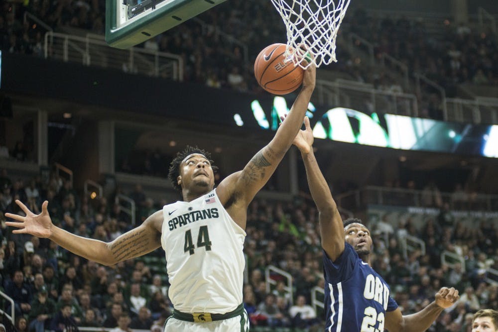 Freshman forward Nick Ward (44) and Oral Roberts forward Emmanuel Nzekwesi (23) fight for a loose ball during the first half of the men's basketball game against Oral Roberts on Dec. 3, 2016 at Breslin Center. 