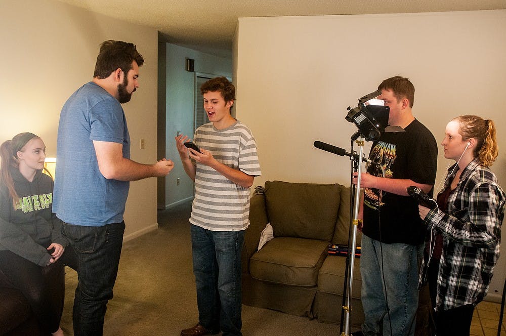 <p>From left, Giraffe House members media and information junior Dani Dillon, computer science junior Michael Pomorski, advertising and communication junior Alex Byers, film studies senior Seth Kalis, and media and information junior Jenna Canning film a sketch for their telecasters show on Oct. 5, 2014, on Spartan Avenue. The Giraffe House films their comedy sketches every Sunday and posts regularly on Youtube. Raymond Williams/The State News</p>