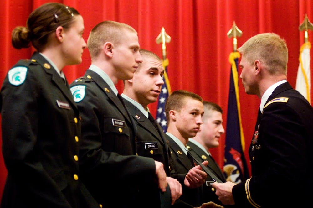 	<p>Criminal justice freshman Joseph Gianino, center, receives the Battalion Commander’s Ribbon along with his fellow cadets from Lt. Col. Jim Rouse during the <span class="caps">ROTC</span> spring awards ceremony on Tuesday evening at Kellogg Center.</p>