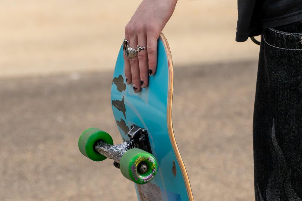 A member of MSU Skate Club holds his skateboard during skate club outside of Shaw Hall on Michigan State University’s campus in East Lansing, Mich., on March 20, 2026.