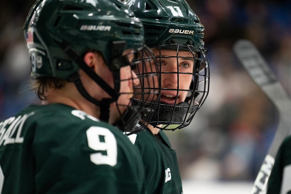 <p>Michigan State freshman forward Owen West (11), right, chats with junior defenseman Matt Basgall (9) during an exhibition game against the under-18 U.S. Men's National Team Development Program at USA Hockey Arena in Plymouth, Michigan on Nov. 21, 2024. In front of a sold out crowd, the Spartans captured a convincing 6-2 victory, showcasing why they deserve their ranking of number two in the nation.</p>