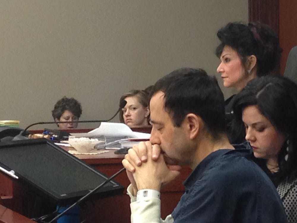 Larry Nassar, Judge Rosemarie Aquilina (above) and Shannon Smith, one of Nassar's attorneys, are seated at the podium during Nassar's sentencing hearing Tuesday.