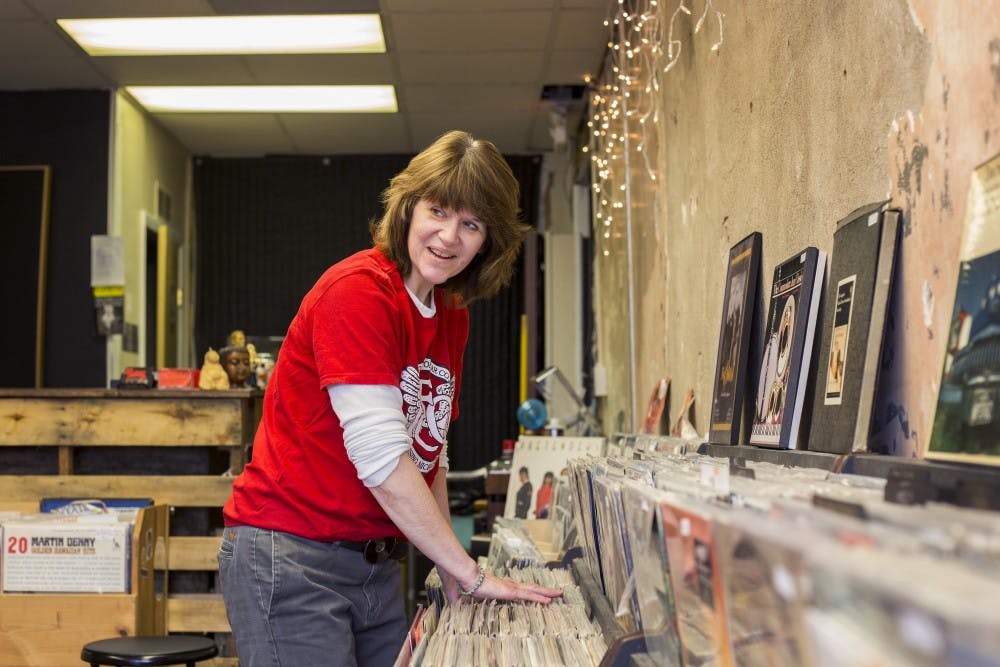 <p>Owner of the Record Lounge Heather Frarey smiles as a customer walks into the store as she organizes vinyls on April 11, 2017 at the new Record Lounge store at 1132 S Washington Ave in Lansing. "It's like a library, nobody ever puts anything back."</p>
<p><strong>State News File Photo</strong></p>