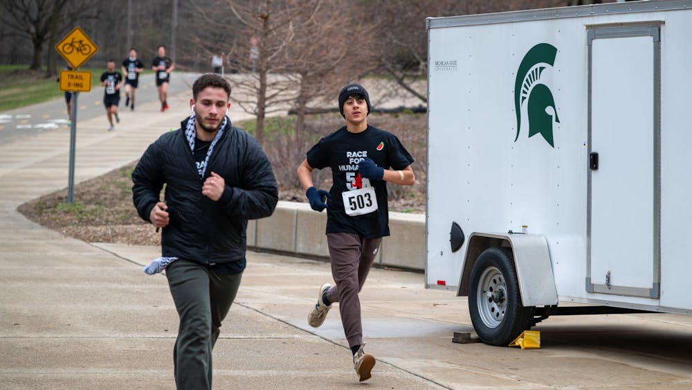 <p>Race For Humanity participants run behind the business building alongside the river on April 13, 2025.</p>