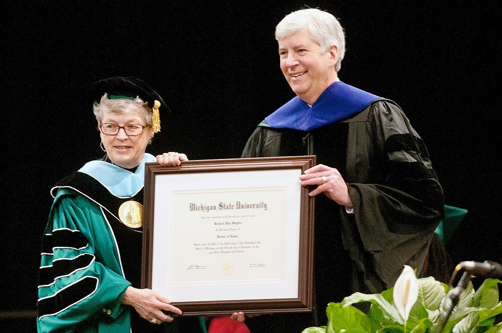 	<p><span class="caps">MSU</span> president Lou Anna K. Simon presents Michigan Gov. Rick Snyder with an honorary Doctors of Law degree to start the commencement ceremony Saturday, Dec. 15, 2012, at Breslin Center. Snyder addressed the <span class="caps">MSU</span> graduating class soon after receiving the honorary degree. Danyelle Morrow/The State News</p>
