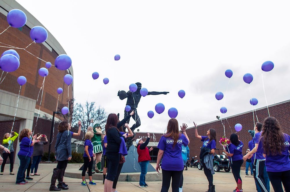 <p>Participants release balloons at Relay For Life on March 28, 2014, at Breslin Center. Students showed their support by staying at the Breslin Center from 6 p.m. until 6 a.m. to raise money for cancer. Allison Brooks/ The State News</p>