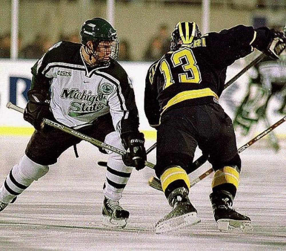 <p>Freshman forward Jim Slater goes up against U-M junior center Mike Cammalleri during an Oct. 6, 2001 game at Spartan Stadium. The game was tied 3-3. (State News File Photo)</p>