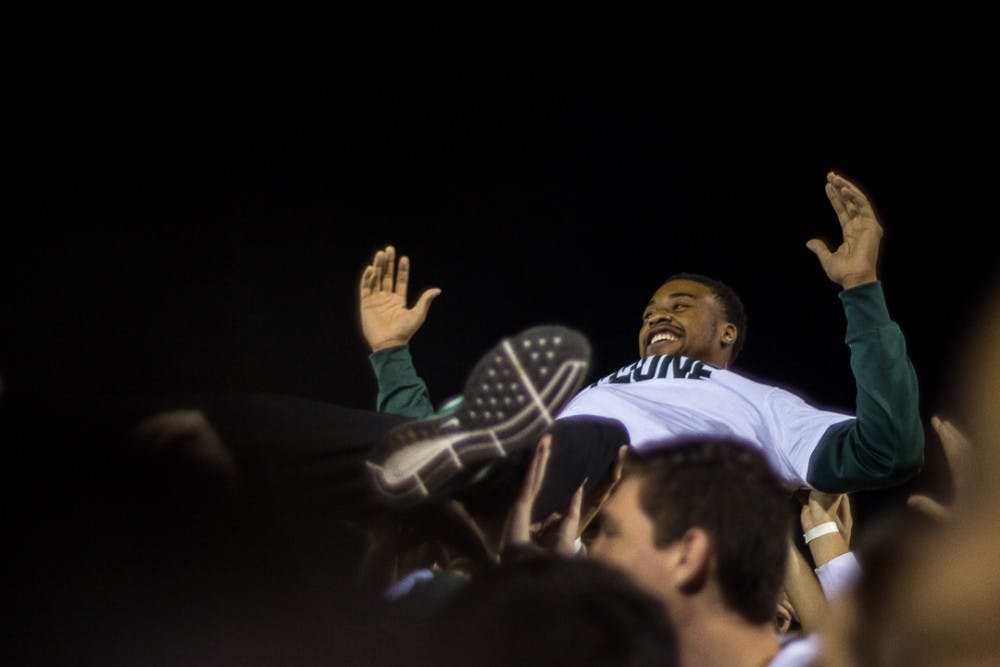 Sophomore forward Nick Ward reacts to crowd surfing during the Izzone Campout on October 13, 2017 at Munn Field. The annual event unites Spartan fans who camp out all night for a chance to access lower bowl seating for the upcoming basketball season.  