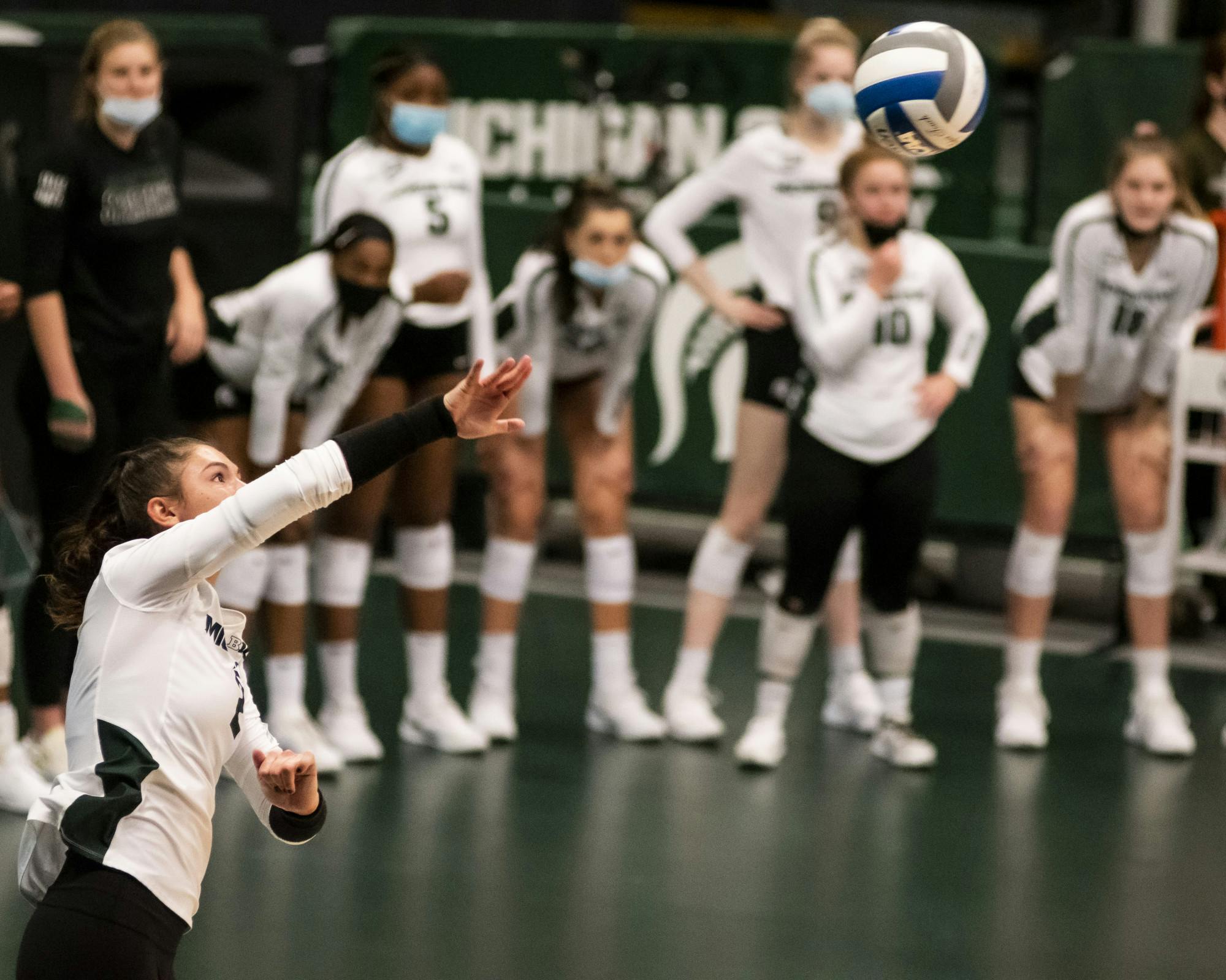 Freshman setter Celia Cullen (2) serves the ball during the game against Rutgers on April 2, 2021, at the Jenison Fieldhouse. The Scarlet Knights defeated the Spartans 3-2.