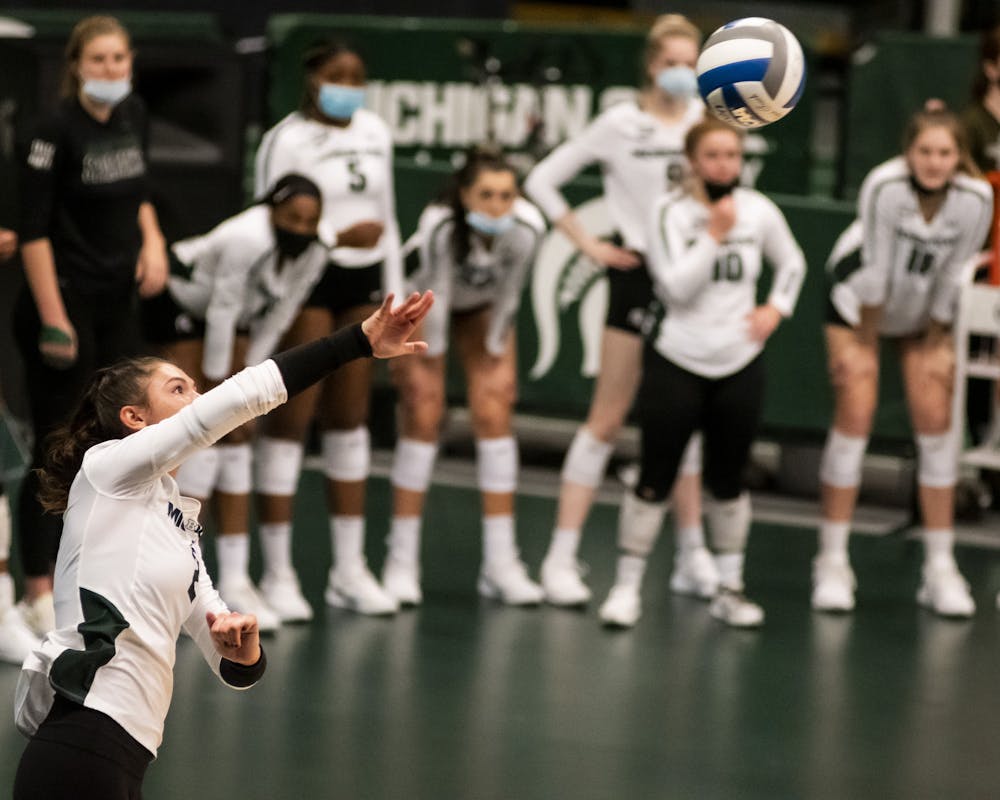 Freshman setter Celia Cullen (2) serves the ball during the game against Rutgers on April 2, 2021, at the Jenison Fieldhouse. The Scarlet Knights defeated the Spartans 3-2.