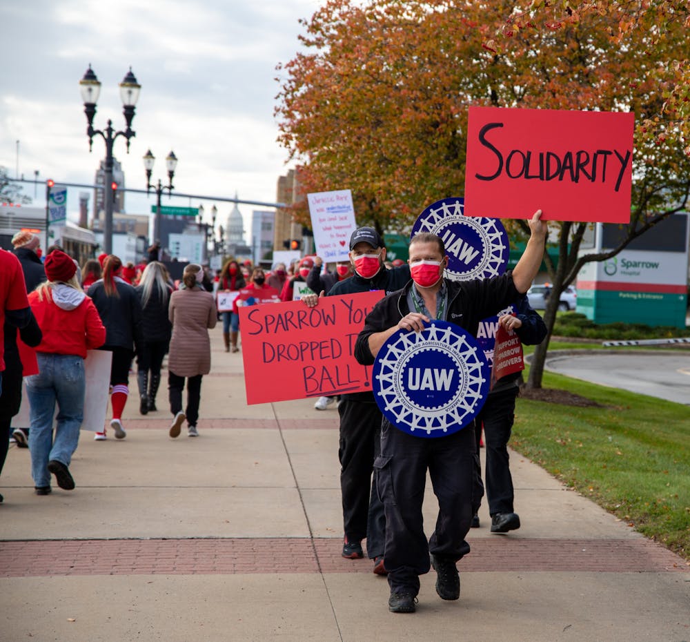 <p>Sparrow nurses along with the general public picket along Michigan Avenue in Lansing on Nov. 3, 2021. Attendees of the event were gathered in support of Sparrow healthcare workers. </p>