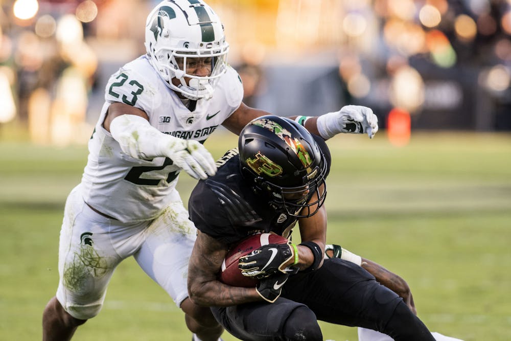 <p>Spartan safety Darius Snow (23) assists in a tackle in MSU’s match against the Purdue Boilermakers at Ross-Ade Stadium in West Lafayette on Saturday, Nov. 6, 2021.</p>