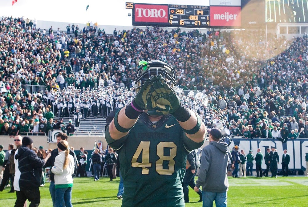 <p>Junior tight end Drew Stevens shows of his Nike Pro Combat gloves after the game Saturday at Spartan Stadium. The Spartans defeated the Michigan Wolverines 28-14. Matt Radick/The State News</p>