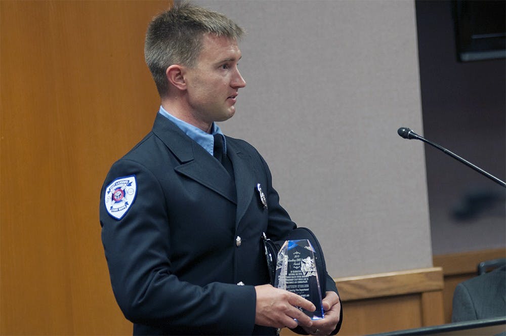 <p>East Lansing Fire Department's Paramedic firefighter Matthew Sterling receives the Paramedic of the Year award inside East Lansing City Hall on August 4, 2015. Joshua Abraham/The State News</p>