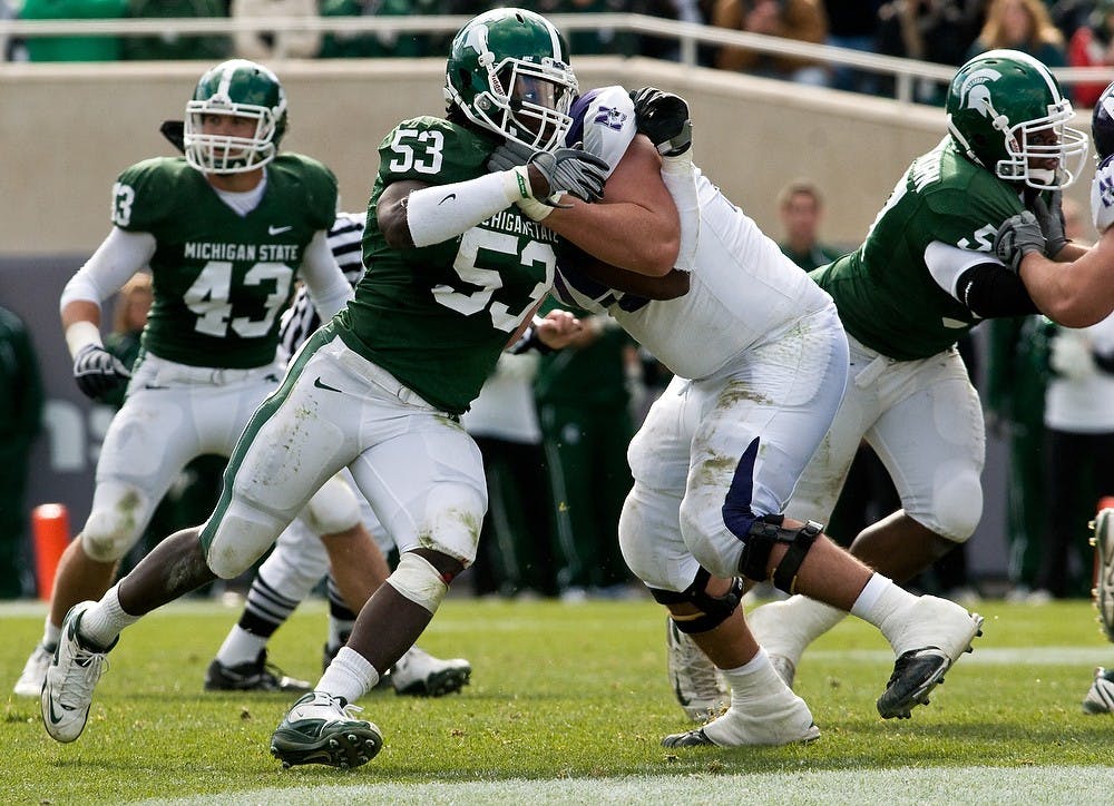 <p>Junior linebacker Greg Jones pushes to get past Wildcat offensive lineman Al Netter late in the fourth quarter of the Spartans 24-14 victory over Northwestern. Jones would end the game with 14 tackles, two of which were sacks. Sean Cook/The State News</p>