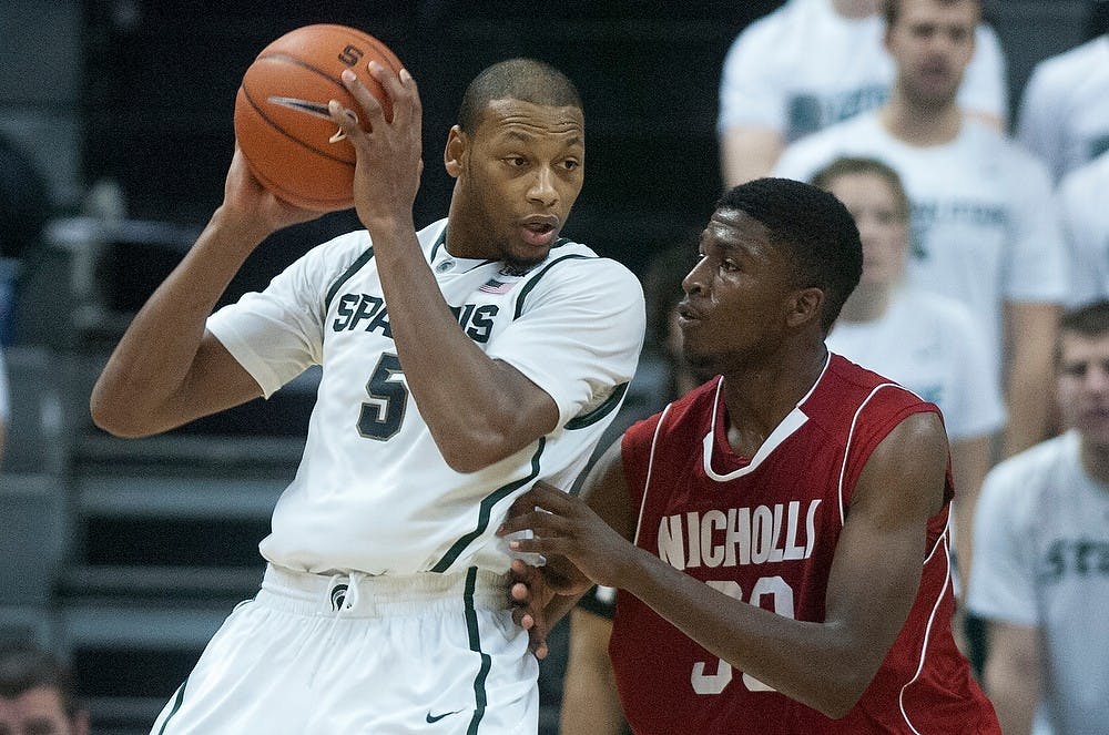 	<p>Junior center Adreian Payne fends off Nicholls State forward JaMarkus Horace on Saturday, Dec. 1, 2012, during the game at Breslin Center. The Spartans defeated the Colonels 84-39. Julia Nagy/The State News</p>