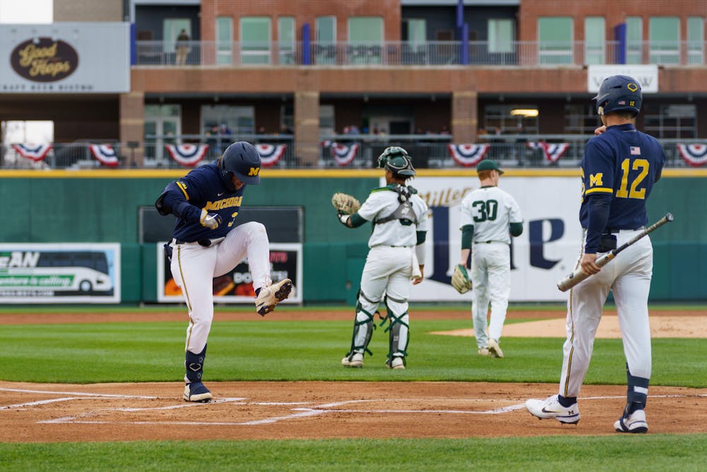 <p>Michigan graduate student third baseman Matt Frey (24) stomping as he crosses home base after he hit a home run in the first inning. Michigan State lost 18-6 to Michigan on April 15, 2022, at the Lugnut Stadium.</p>