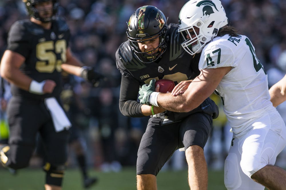 <p>Spartan sophomore defensive end Jeff Pietrowski (47) tackles O&#x27;Connell (16) in MSU’s match against the Purdue Boilermakers at Ross-Ade Stadium in West Lafayette on Saturday, Nov. 6, 2021.</p>