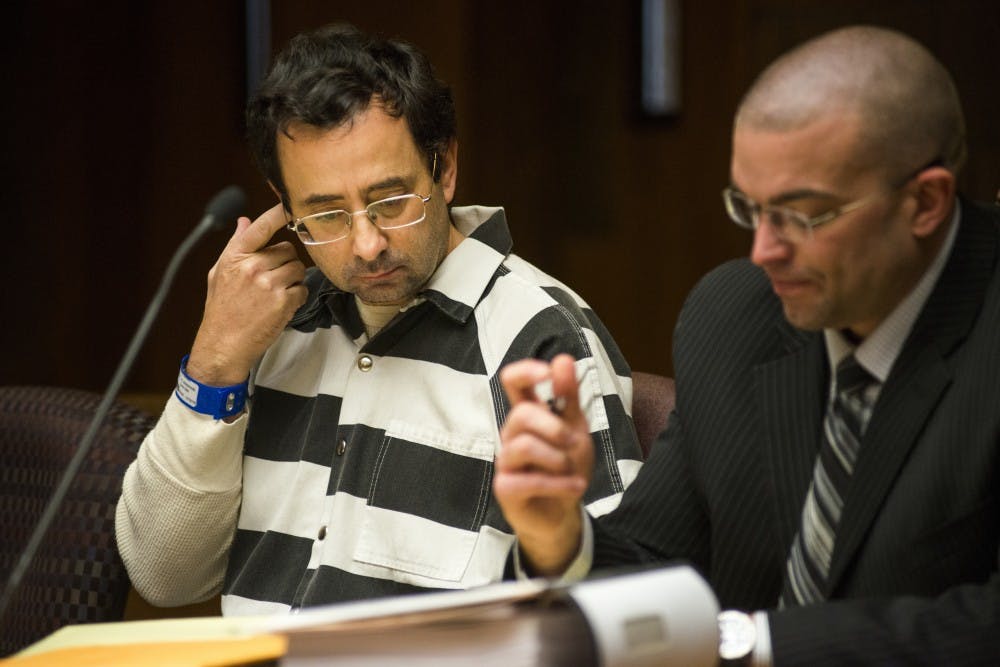 Former MSU employee Larry Nassar scratches his ear during the preliminary examination on Feb. 17, 2017 at 55th District Court in Mason, Mich. The preliminary examination occurred as a result of former MSU employee Larry Nassar's alleged sexual abuse.