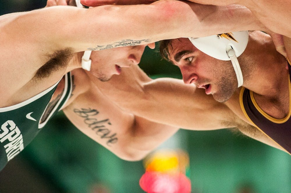 Redshirt freshman 157-pounder Jake Tucker wrestles with Arizona State's redshirt senior Oliver Pierce during the Michigan State Open on Nov. 5, 2017 at Jenison Fieldhouse. Tucker won the match 5-3. 