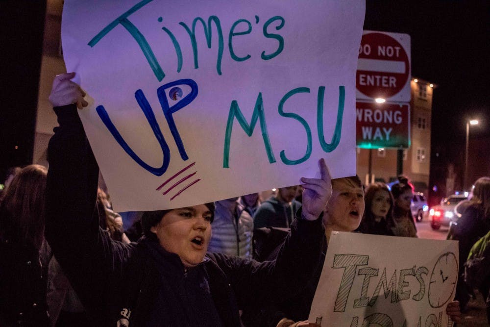 Doctoral student Julia Gibson joins the crowd in chanting during the March for Survivors and Change on Jan. 26, 2018, on Harrison Road.