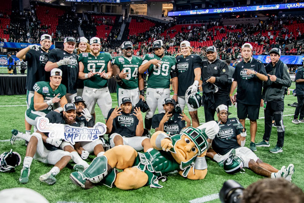 <p>The Spartans celebrate their Peach Bowl victory on Mercedes-Benz field. Dec. 30, 2021.</p>