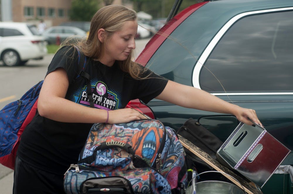 <p>Advertising freshman Samantha Inman moves into her dorm on Aug. 30, 2015, at Brody Complex. Courtney Kendler/The State News</p>