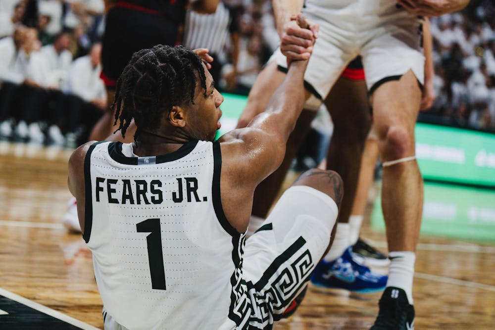 MSU sophomore guard Jeremy Fears Jr. (1) is helped up by his teammates during an exhibition matchup against Ferris State at the Breslin Center on Oct. 29, 2024.