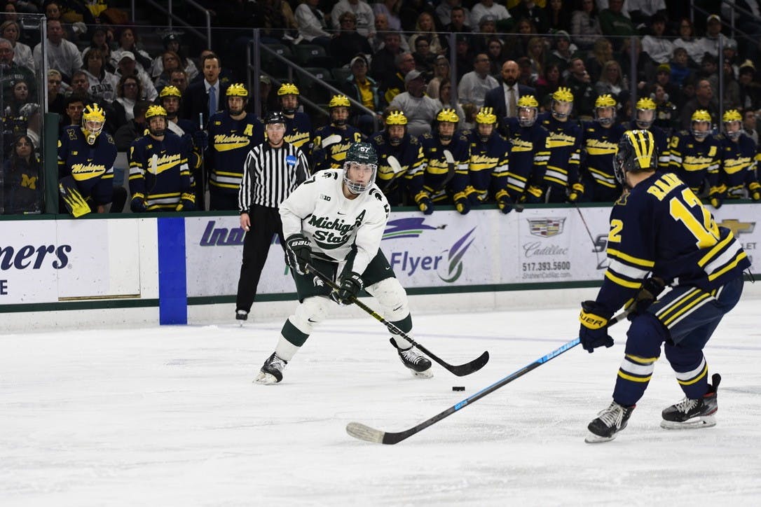 Redshirt senior defenseman Jerad Rosburg (16) evaluates his options during the game against Michigan on Feb. 14, 2020 at the Munn Ice Arena. MSU fell to U of M 5-1.
