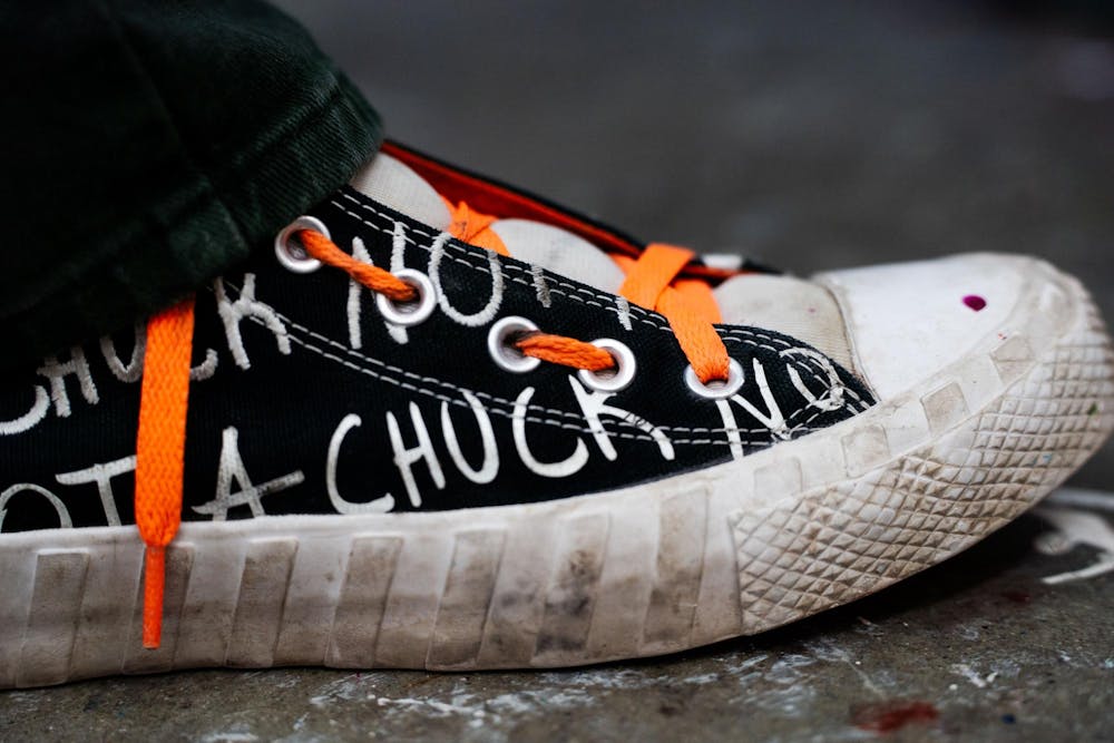 Fourth-year Michigan State studio art student Evan Yalowitz taps her foot to the music playing in her headphones as she paints in her studio at Kresge Art Center on April 4, 2025. “A lot of what drives all of my pieces is just music,” Yalowitz said.