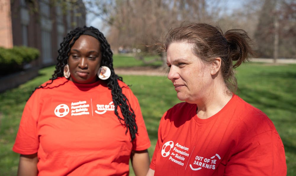 Out of the Darkness 5k walk co-chairs and Michigan State Counseling & Psychiatric Services counselors Courtney Brown, left, and Sarah Fay-koutz, right, at People's Park on April 14, 2024.