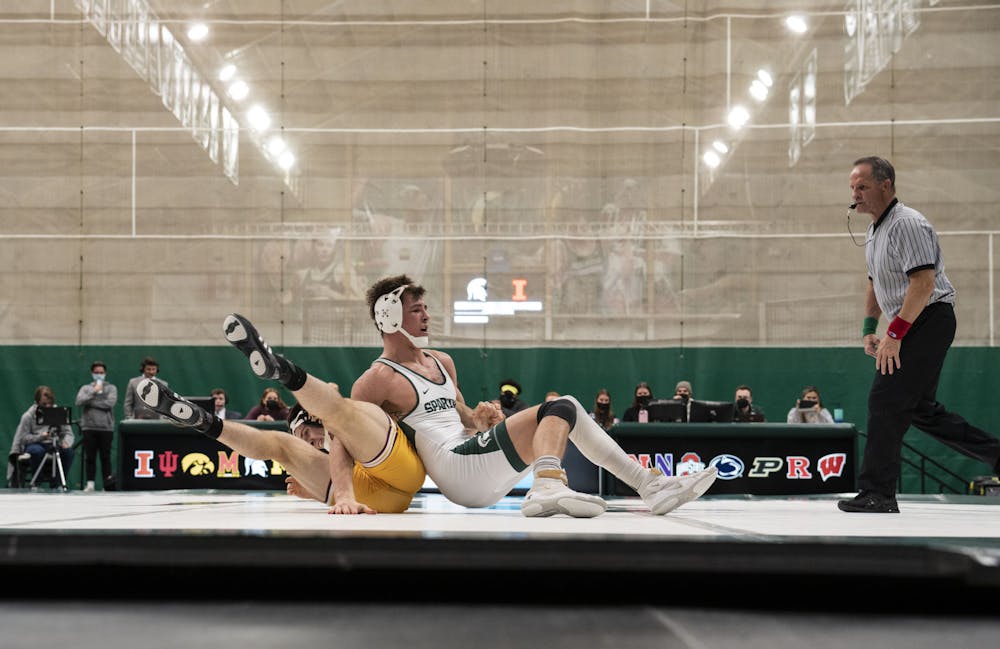<p>Redshirt junior Layne Malczewski scores a reversal over Central&#x27;s Ben Cushman in MSU’s match against Central at Jenison Field House on Friday, Feb. 18, 2022. </p>