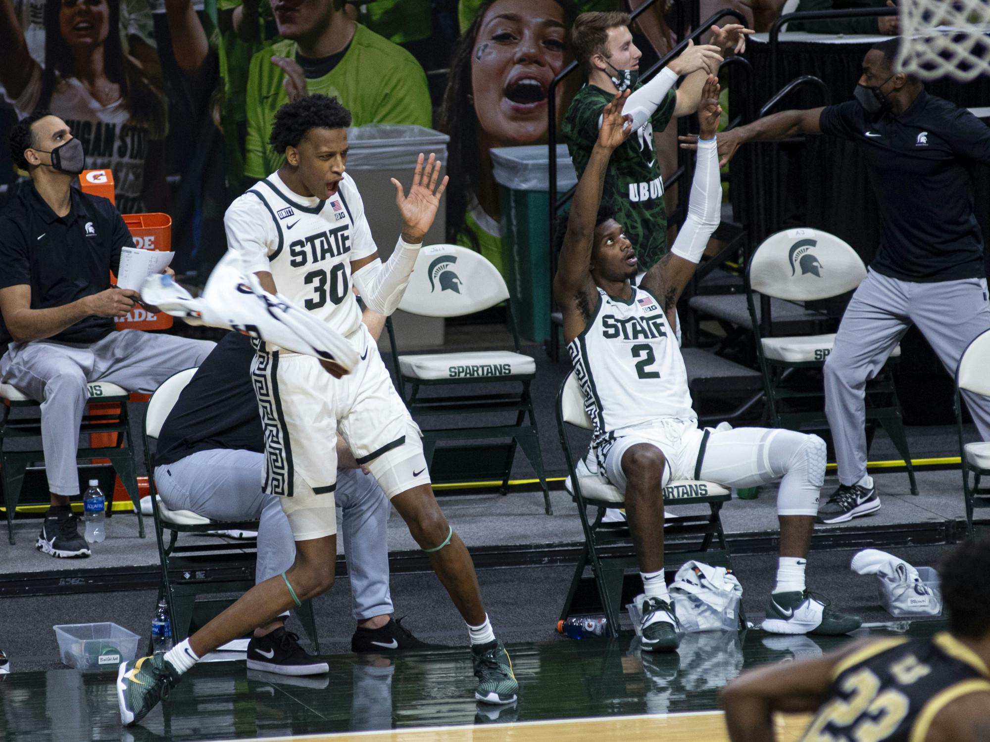 <p>Junior forward Marcus Bingham Jr. (30) celebrates his team scoring by dancing with a towel in the second half. The Spartans came back in the second half to end the game against the Broncos 79-61 on Dec. 6, 2020.</p>