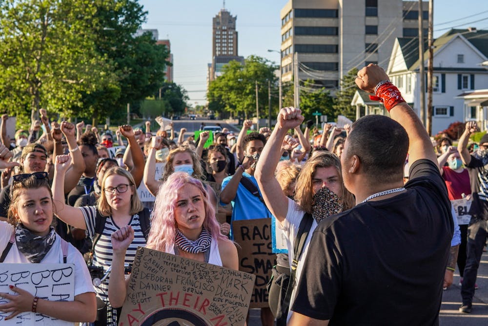 <p>Paul Birdsong, front, prepares protesters for a long march from the Capitol to Lansing Mayor Andy Schor’s house June 6, 2020.</p>