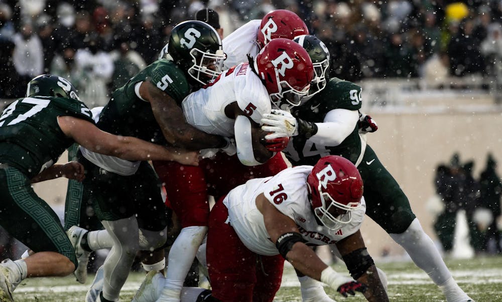 <p>A pileup forms around Rutgers senior running back Kyle Monangai (5) as MSU defenders try to bring him down at Spartan Stadium on Nov. 30, 2024.</p>