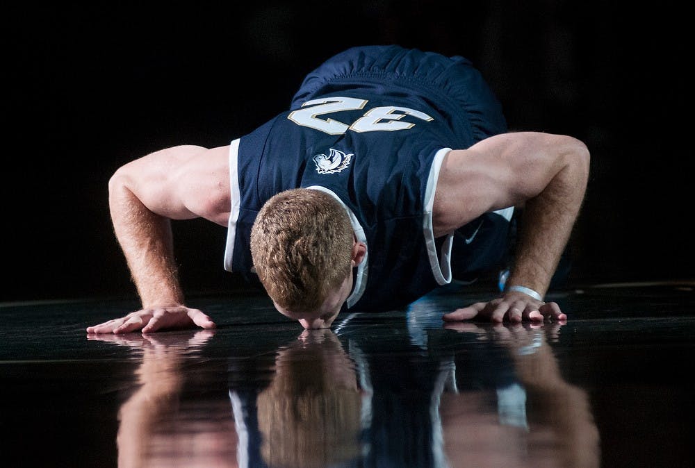 <p>The Master's College guard Russell Byrd kisses the court before the game on Nov. 3, 2014 at the Breslin Center. The Spartans defeated the Mustangs, 97-56. Aerika Williams/The State News.</p>